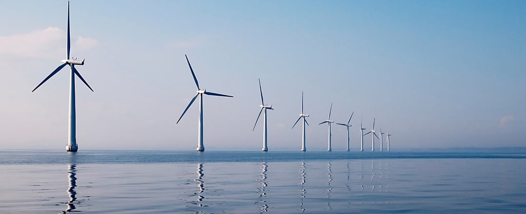 Row of wind turbines in sea, calm water
